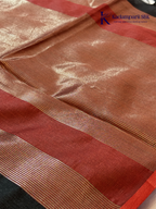 Black semi raw silk saree with red butta motifs, elegant zari woven border and pallu, soft lightweight texture, tassel detailing, and traditional ethnic styling by Kadamparii Silk.