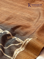 Grey Chenderi silk cotton saree with elegant floral vine design, intricate French knot work, copper-toned border and pallu, soft lightweight fabric, tassel detailing, and graceful ethnic styling by Kadamparii Silk.