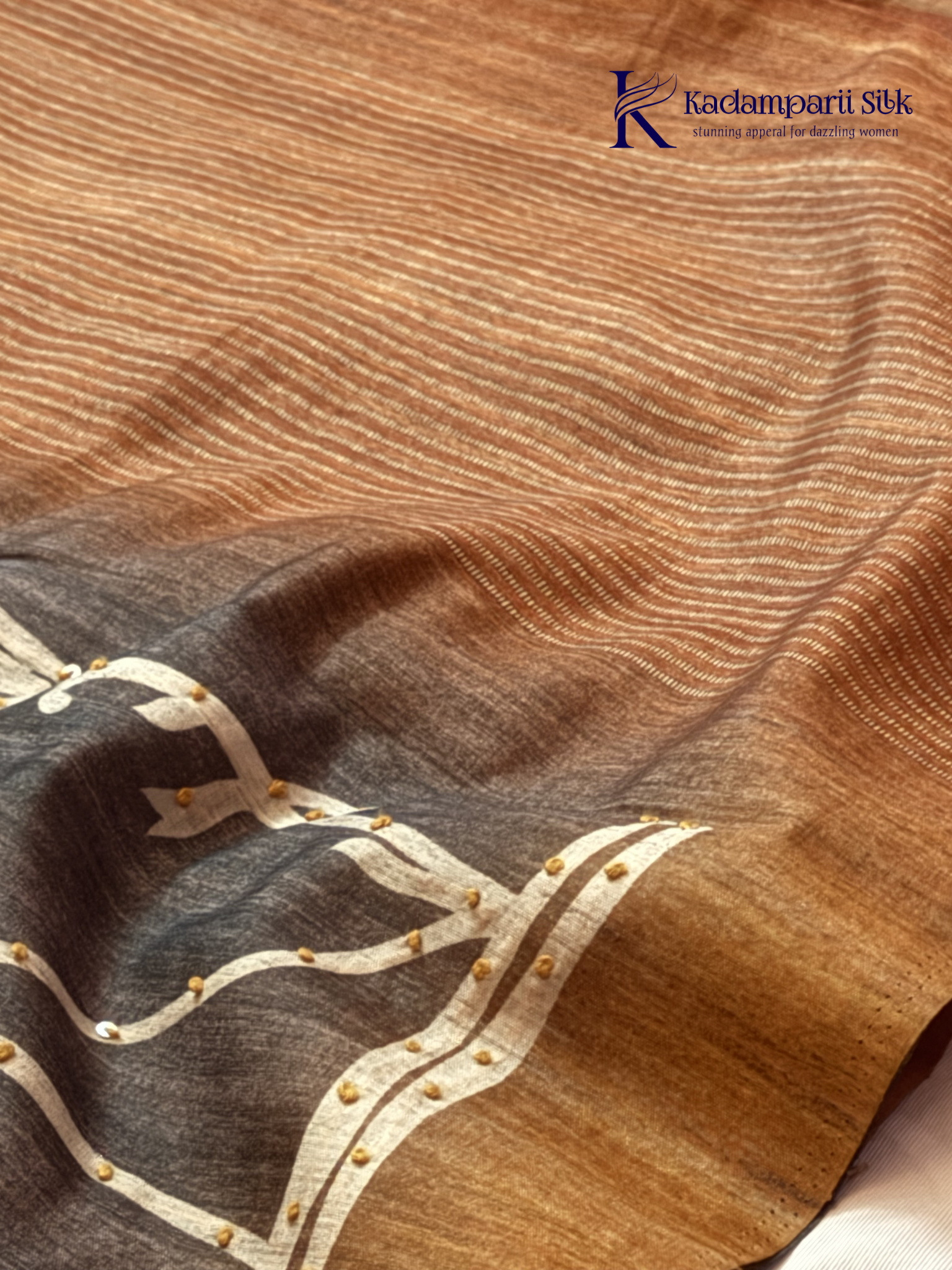 Grey Chenderi silk cotton saree with elegant floral vine design, intricate French knot work, copper-toned border and pallu, soft lightweight fabric, tassel detailing, and graceful ethnic styling by Kadamparii Silk.