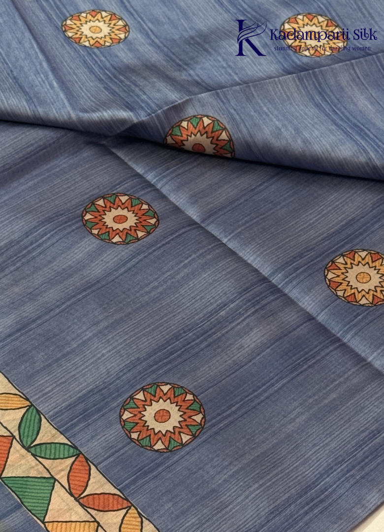 Kadamparii Silk dusty blue semi tussar silk saree with floral printed mundhi and multicolour border, displayed on a white background.