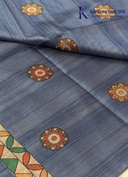 Kadamparii Silk dusty blue semi tussar silk saree with floral printed mundhi and multicolour border, displayed on a white background.