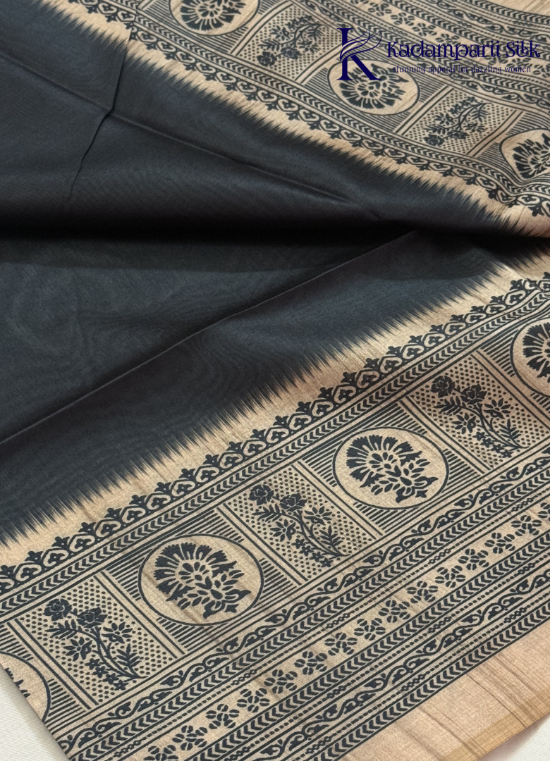 Kadamparii Silk black semi tussar silk saree with traditional printed mundhi and beige border, displayed on a white background.