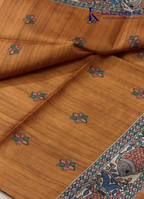 Kadamparii Silk mustard semi tussar silk saree with artistic printed mundhi and colourful floral traditional motifs, displayed on a white background.