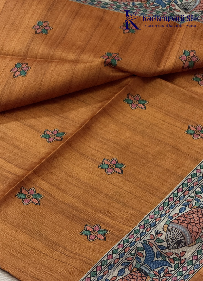 Kadamparii Silk mustard semi tussar silk saree with artistic printed mundhi and colourful floral traditional motifs, displayed on a white background.