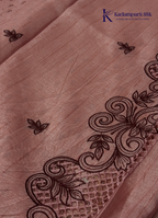 Kadamparii Silk dusty pink raw silk saree with embroidery work, subtle body motifs, and decorative border, displayed on a white background.