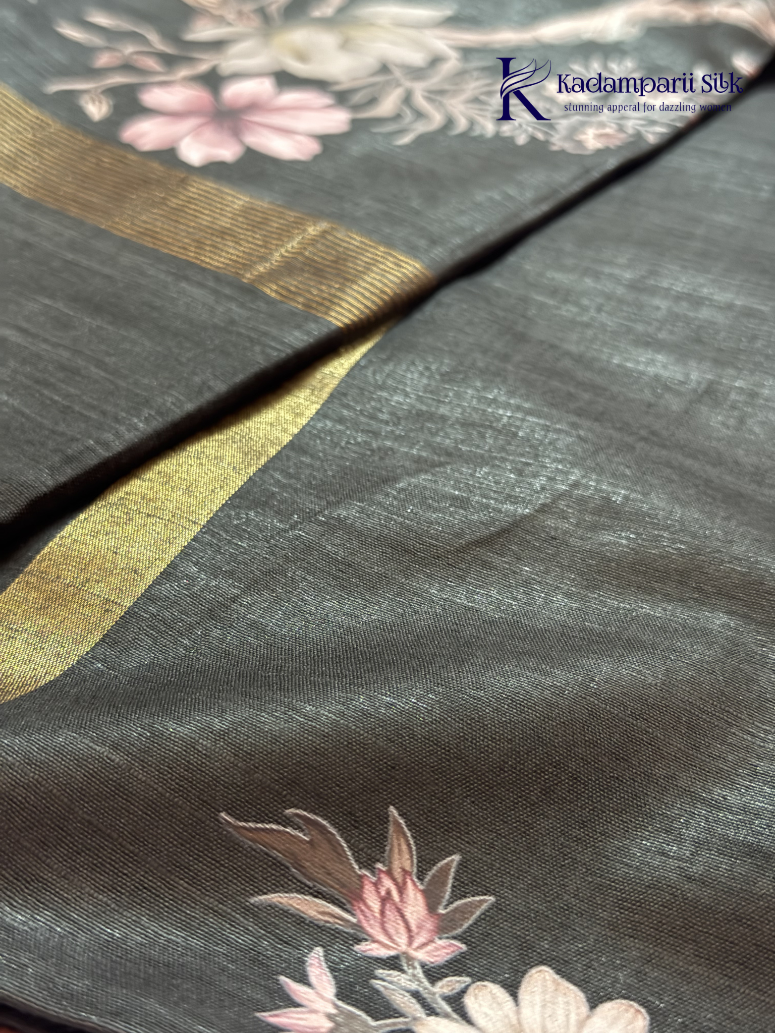 Black semi tussar saree with floral digital print and subtle golden zari border by Kadamparii Silk.