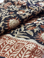 Black Jaipur cotton saree with floral Kalamkari print and traditional printed border by Kadamparii Silk.