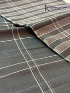 Charcoal grey pure handloom cotton saree with woven stripe and check pattern by Kadamparii Silk.