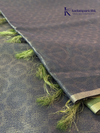 Charcoal grey semi Tussar jacquard saree with intricate woven self-patterns, subtle silver zari border, soft textured finish, elegant tassels, and lightweight graceful drape by Kadamparii Silk.