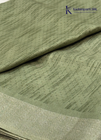 Kadamparii Silk olive green soft tussar silk saree with textured woven body and silver zari border, displayed on a white background.