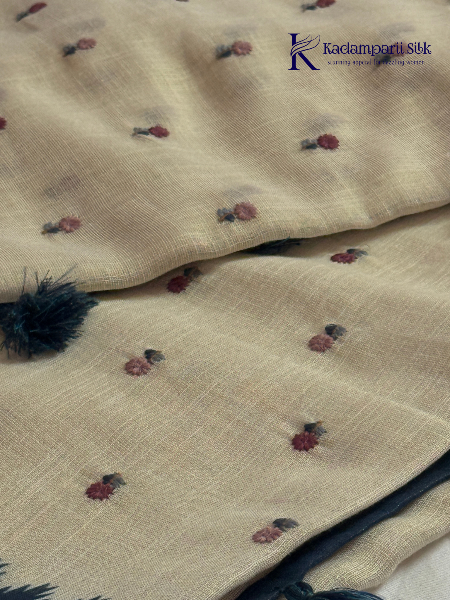 Ivory linen tissue saree with delicate handwork floral embroidery, elegant blue tissue pallu and border, soft lightweight texture, tassel detailing, and graceful ethnic styling by Kadamparii Silk.