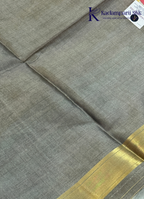 Kadamparii Silk pink semi raw silk saree with zari work and copper patterned border, folded on a light background.