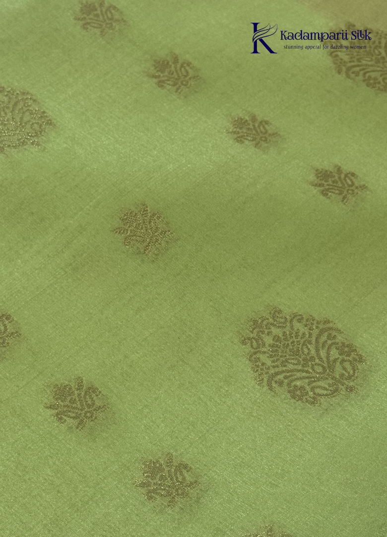 Kadamparii Silk light green raw silk saree with peach zari border and elegant butta detailing, displayed on a white background.