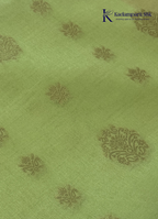 Kadamparii Silk light green raw silk saree with peach zari border and elegant butta detailing, displayed on a white background.