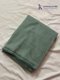 Sage green super net saree with elegant wave-pattern fancy embroidery, subtle shimmer detailing, delicate lace border, lightweight sheer texture, and graceful contemporary drape by Kadamparii Silk.