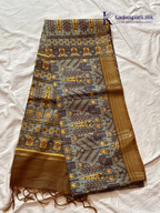 Kadamparii Silk grey semi tussar printed saree with traditional floral and heritage motifs, golden woven border, soft textured fabric, elegant tassels, and sophisticated ethnic design.