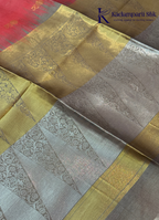 Kadamparii Silk pink semi raw silk saree with zari work and copper patterned border, folded on a light background.
