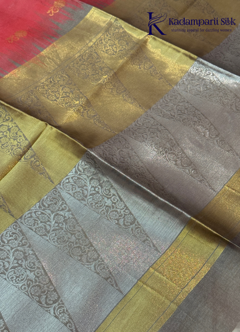 Kadamparii Silk pink semi raw silk saree with zari work and copper patterned border, folded on a light background.
