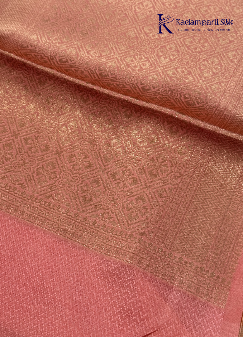 Kadamparii Silk light green raw silk saree with peach zari border and elegant butta detailing, displayed on a white background.