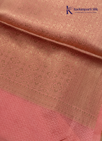 Kadamparii Silk light green raw silk saree with peach zari border and elegant butta detailing, displayed on a white background.