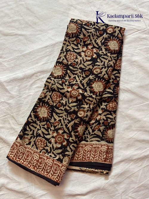 Black Jaipur cotton saree with floral Kalamkari print and traditional printed border by Kadamparii Silk.