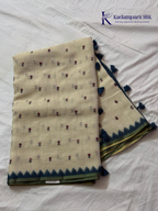 Ivory linen tissue saree with delicate handwork floral embroidery, elegant blue tissue pallu and border, soft lightweight texture, tassel detailing, and graceful ethnic styling by Kadamparii Silk.