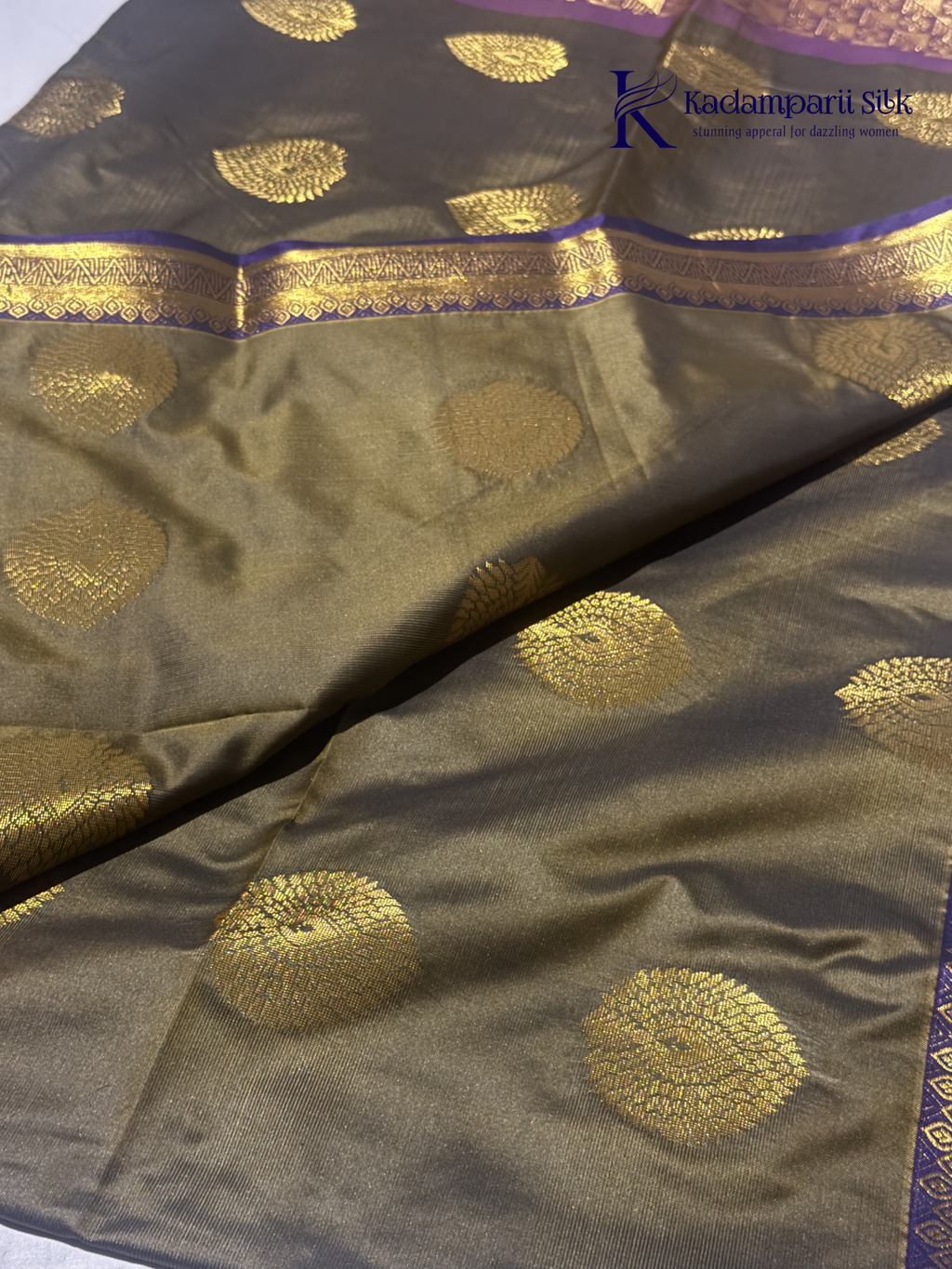 Kadamparii Silk olive green semi soft silk saree with gold zari peacock motifs, rich purple woven pallu, intricate zari border, and tassel detailing.