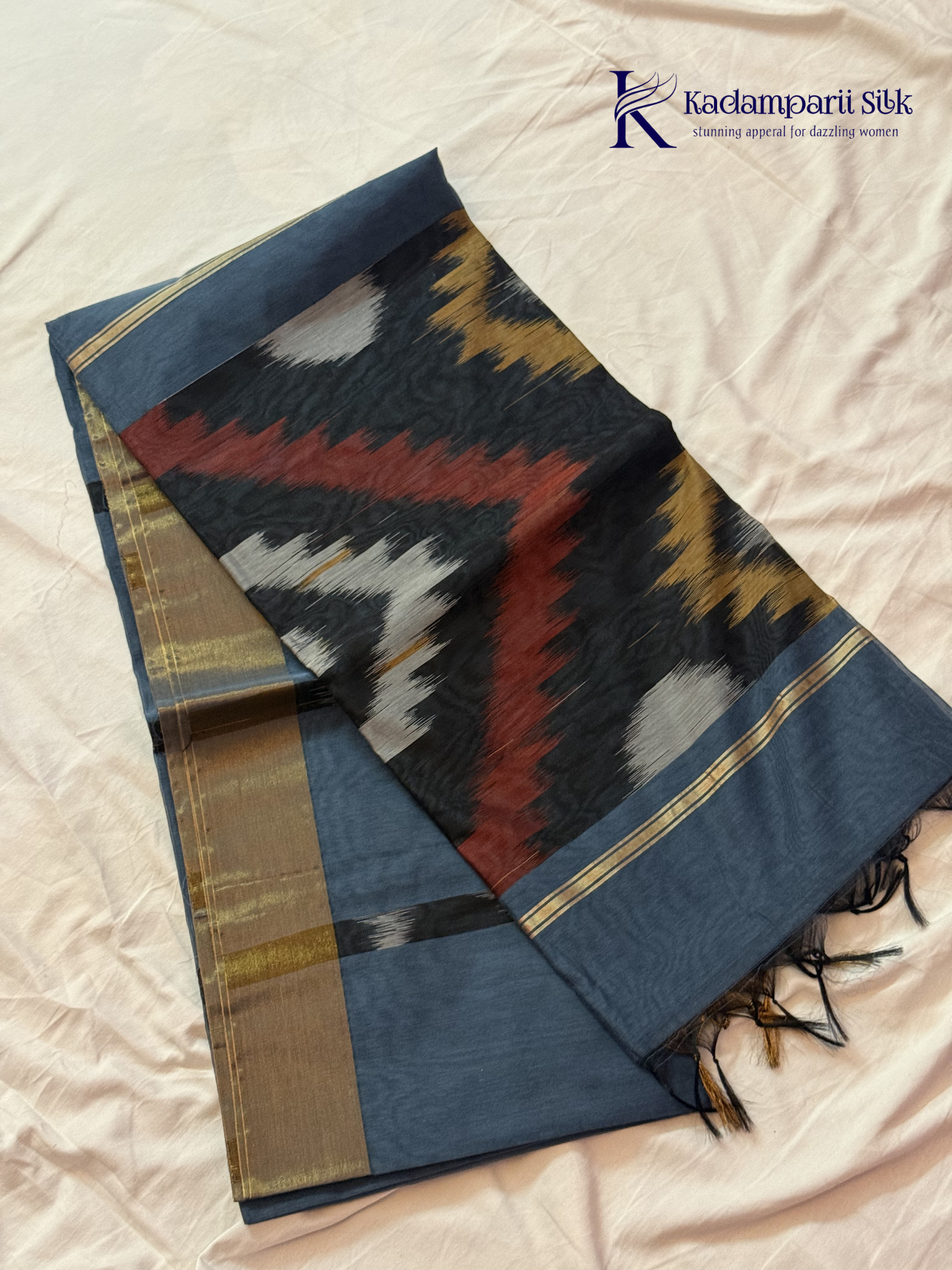 Kadamparii Silk blue Pochampally silk cotton saree with bold ikat geometric patterns, golden zari border, soft lightweight fabric, elegant tassels, and traditional handloom-inspired ethnic design.