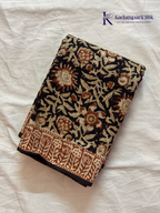 Black Jaipur cotton saree with floral Kalamkari print and traditional printed border by Kadamparii Silk.