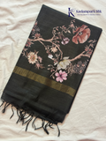 Black semi tussar saree with floral digital print and subtle golden zari border by Kadamparii Silk.