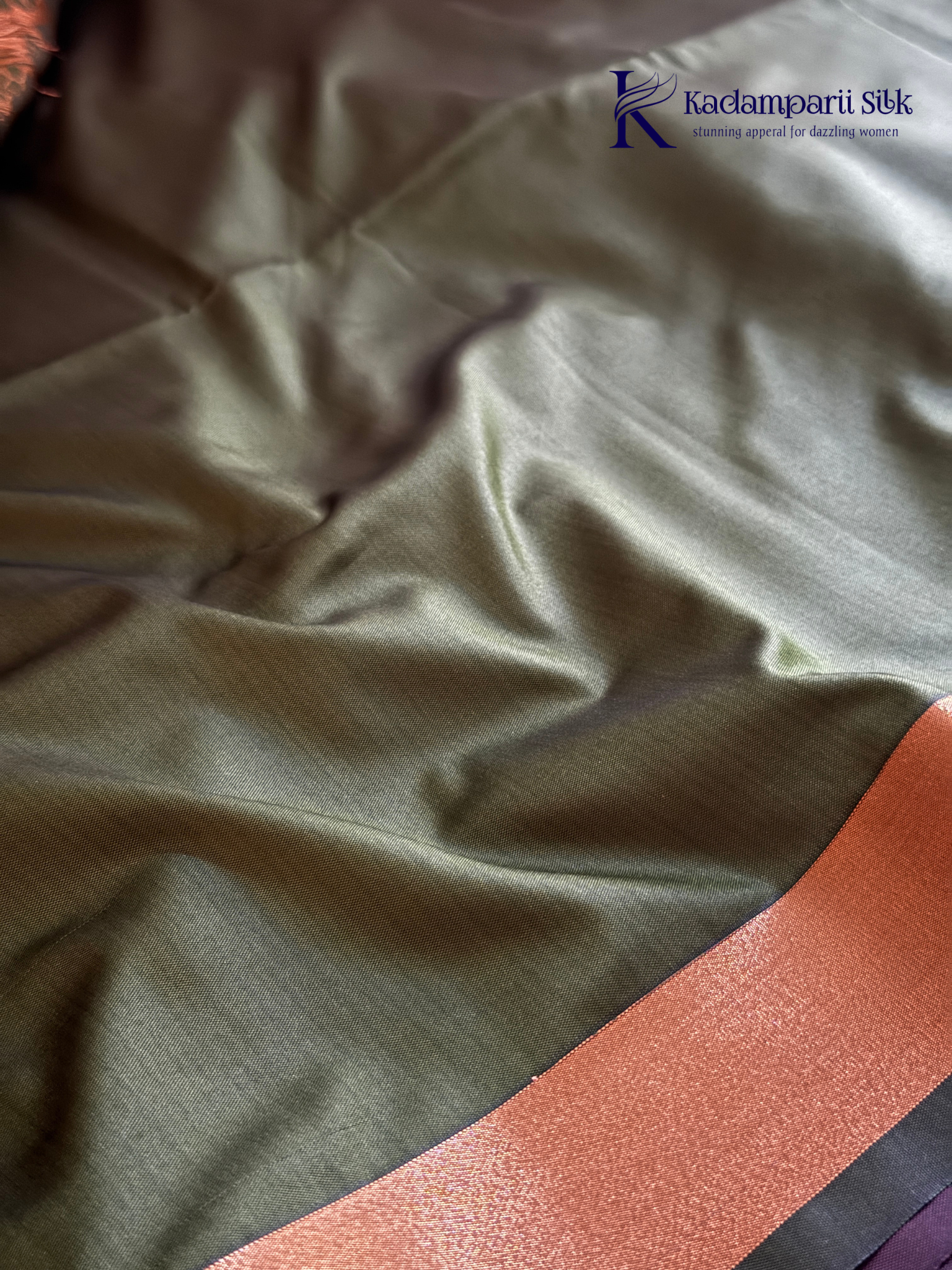 Kadamparii Silk taupe brown semi soft silk saree with olive green zari woven pallu, intricate checkered and floral vine motifs, copper gold zari border, elegant tassels, and traditional festive design.