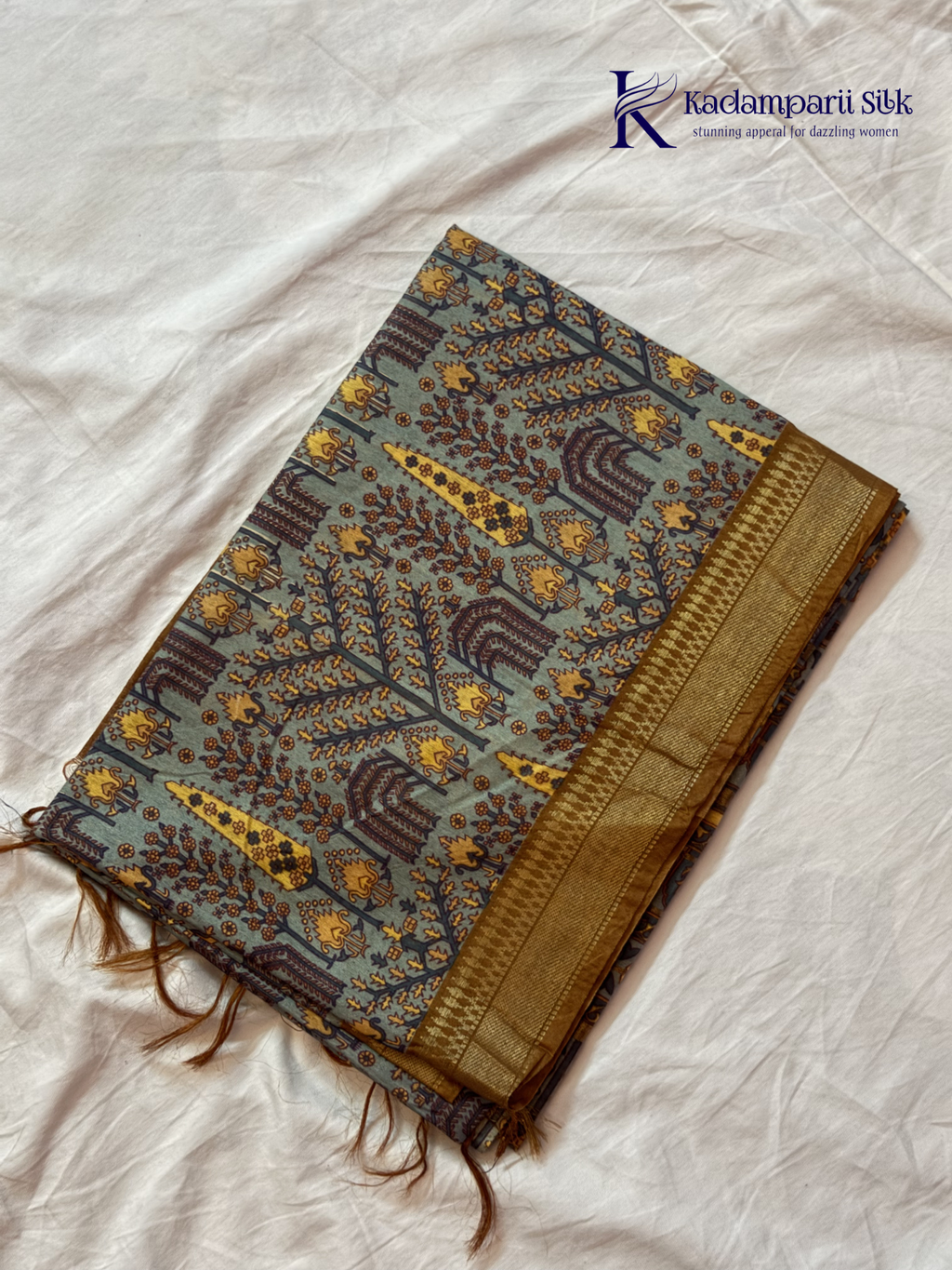 Kadamparii Silk grey semi tussar printed saree with traditional floral and heritage motifs, golden woven border, soft textured fabric, elegant tassels, and sophisticated ethnic design.