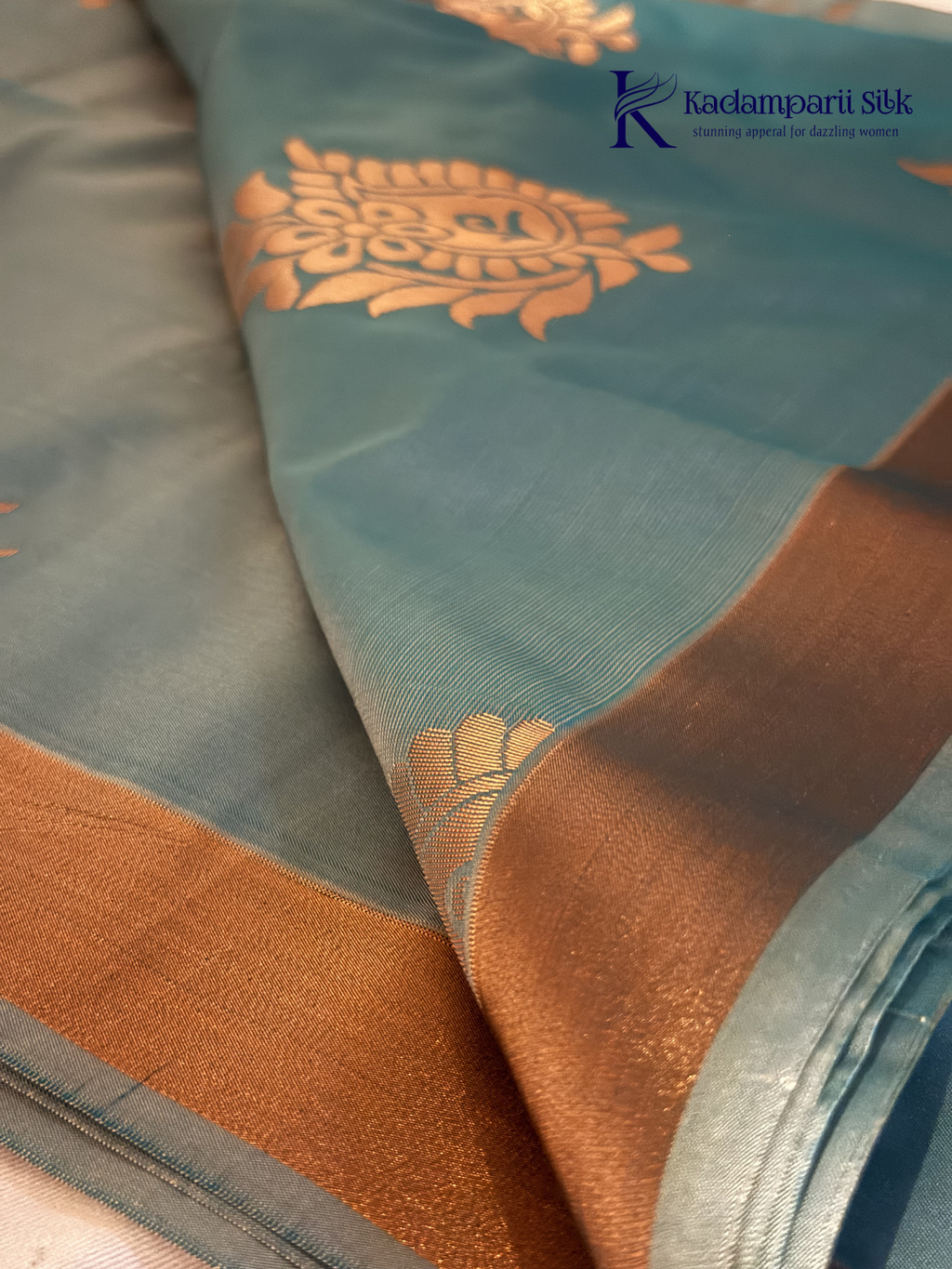 Kadamparii Silk aqua blue semi soft silk saree with magenta zari woven pallu, intricate paisley motifs, floral zari patterns, copper gold border, elegant tassels, and traditional festive design.
