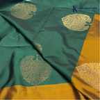 Kadamparii Silk emerald green semi soft silk saree with antique gold zari border, floral woven motifs, rich zari pallu, and elegant tassel detailing.