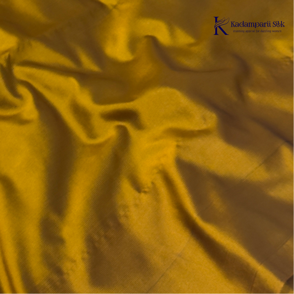 Kadamparii Silk emerald green semi soft silk saree with antique gold zari border, floral woven motifs, rich zari pallu, and elegant tassel detailing.