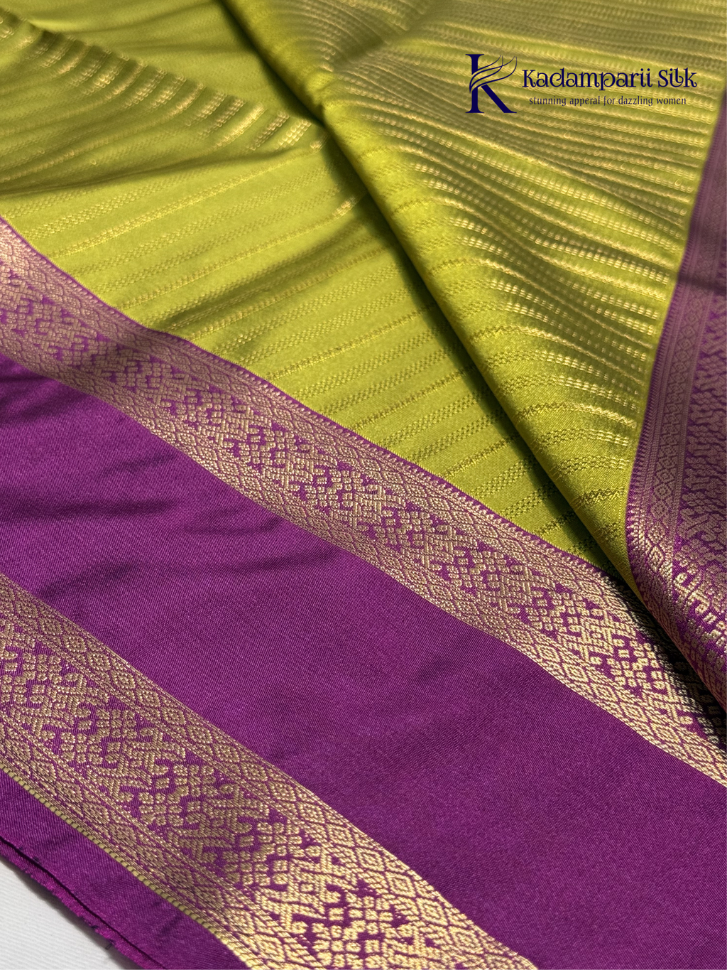 Kadamparii Silk parrot green and magenta semi soft silk saree with gold zari stripes, traditional woven border, rich zari pallu, and tassel detailing.
