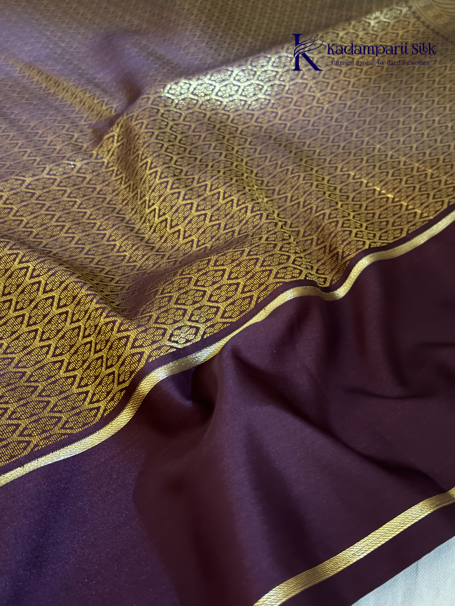 Kadamparii Silk royal wine semi soft silk checked saree with golden zari border, traditional woven pallu, and tassel detailing.