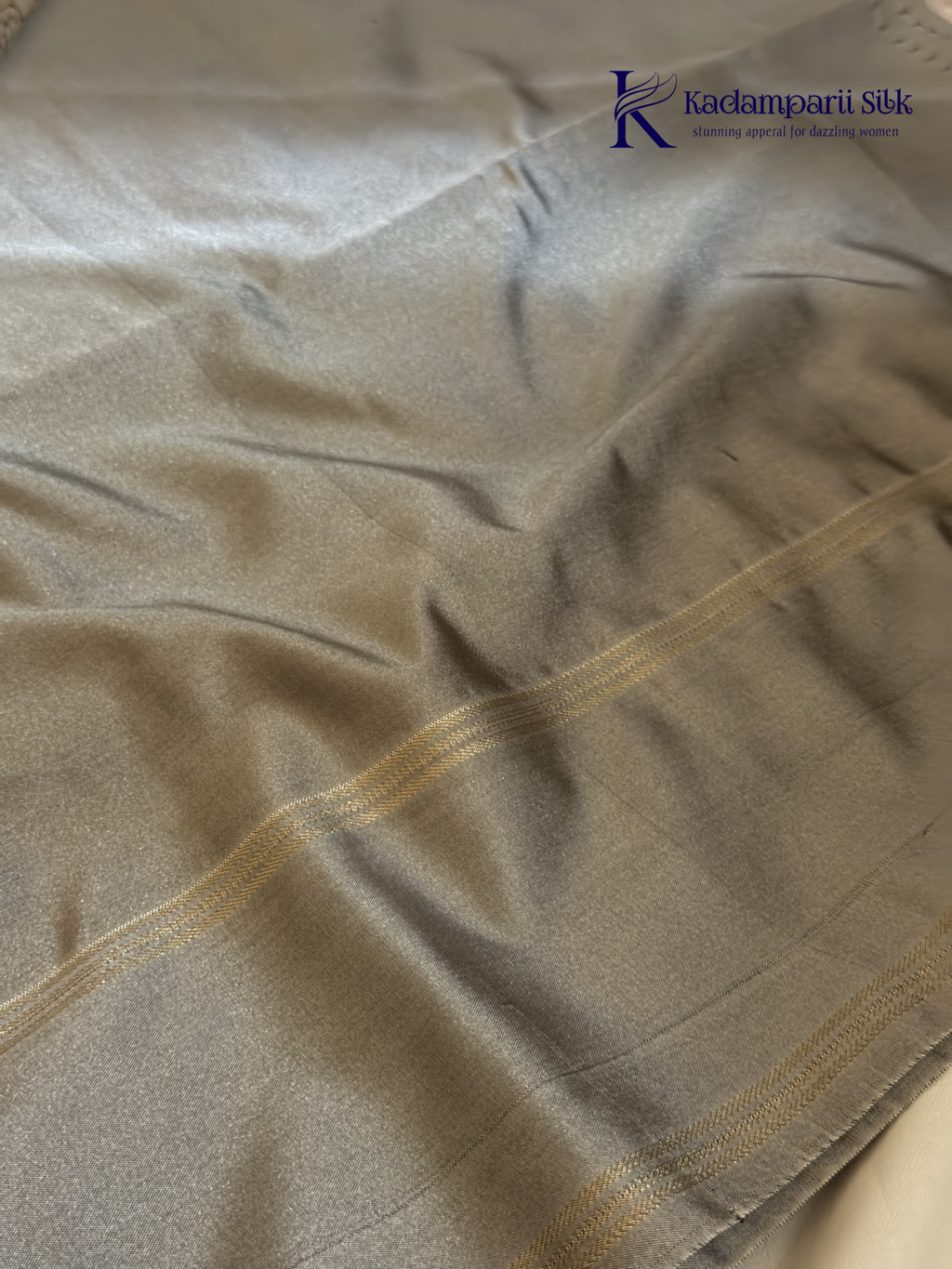Kadamparii Silk royal purple semi soft silk saree with silver zari woven pallu, floral motifs, elegant border detailing, and tassel finish.
