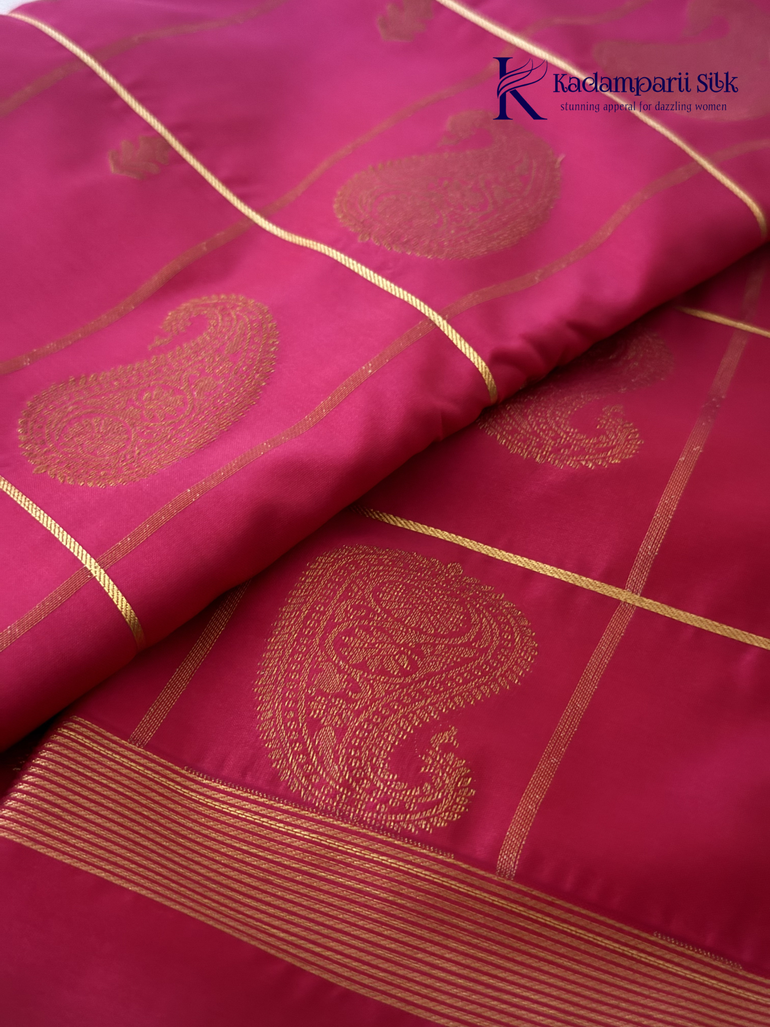 Pink art silk saree with mustard zari border and traditional gold woven motifs displayed on white background Kadamparii Silk