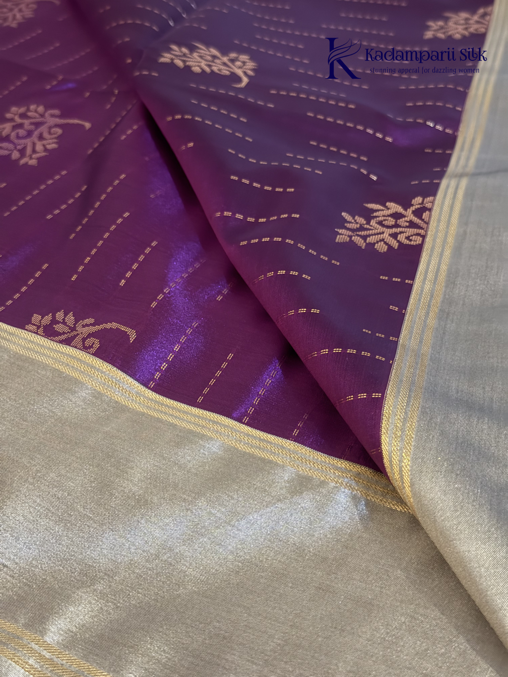 Kadamparii Silk royal purple semi soft silk saree with silver zari woven pallu, floral motifs, elegant border detailing, and tassel finish.