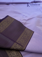 Lavender art silk saree with royal purple zari woven border and gold stripe detailing displayed on white background Kadamparii Silk