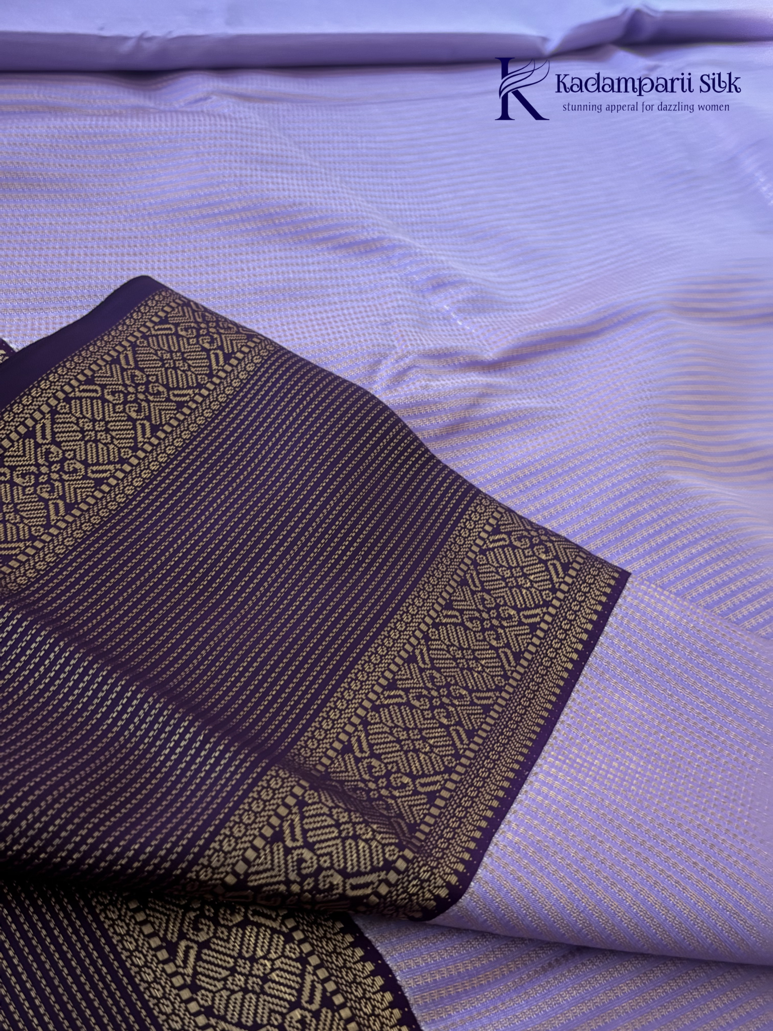 Lavender art silk saree with royal purple zari woven border and gold stripe detailing displayed on white background Kadamparii Silk