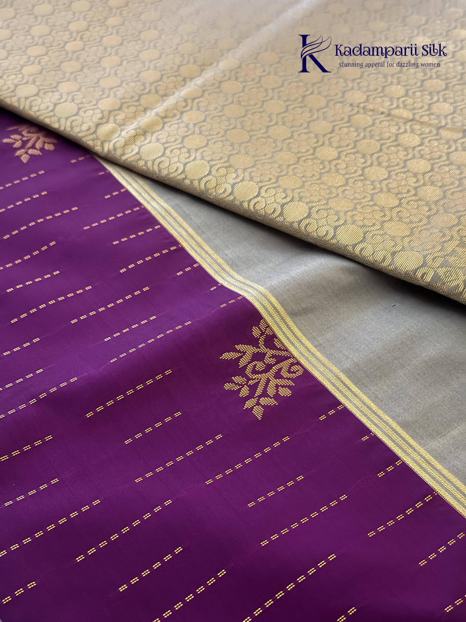 Kadamparii Silk royal purple semi soft silk saree with silver zari woven pallu, floral motifs, elegant border detailing, and tassel finish.