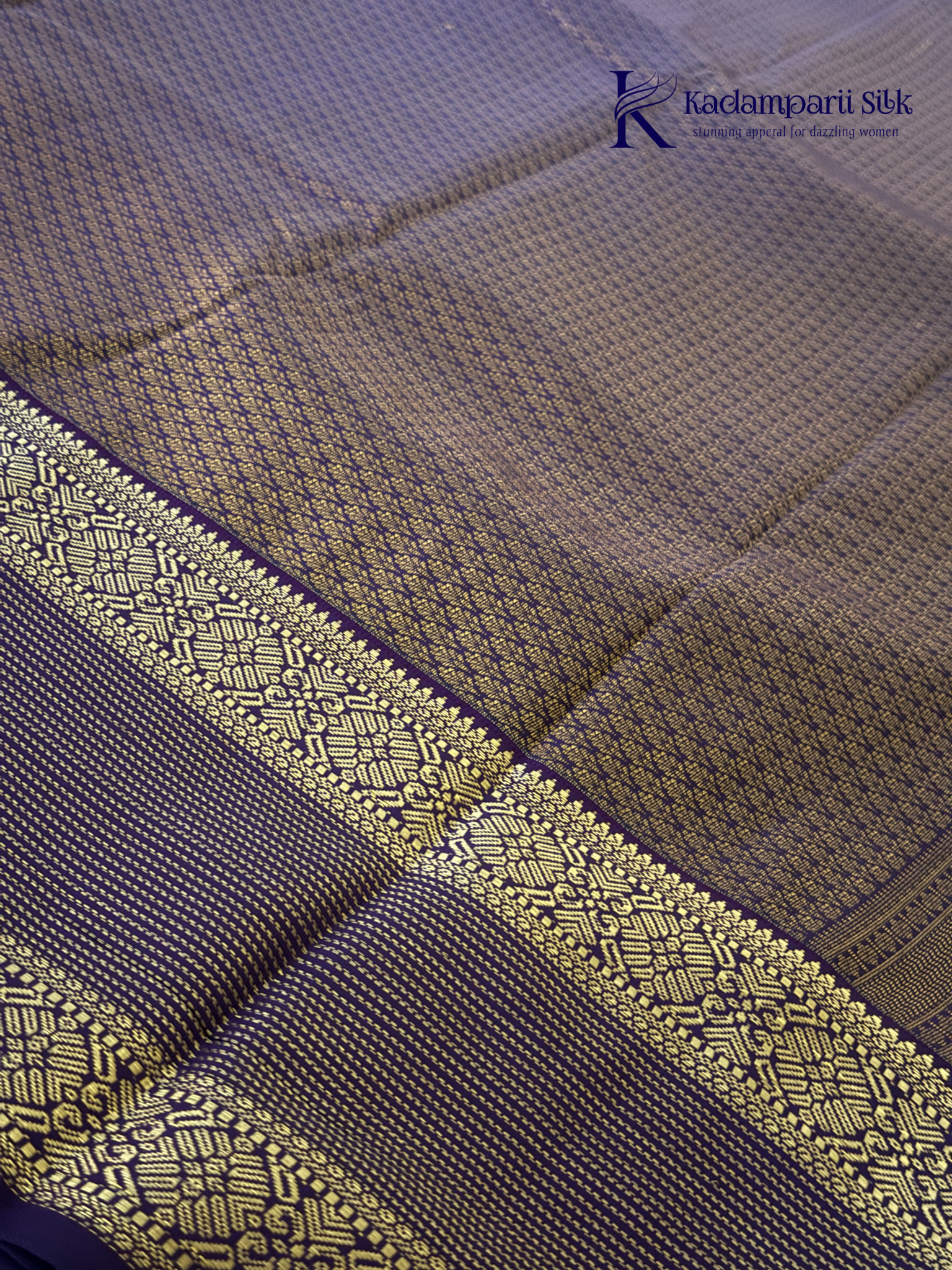Lavender art silk saree with royal purple zari woven border and gold stripe detailing displayed on white background Kadamparii Silk