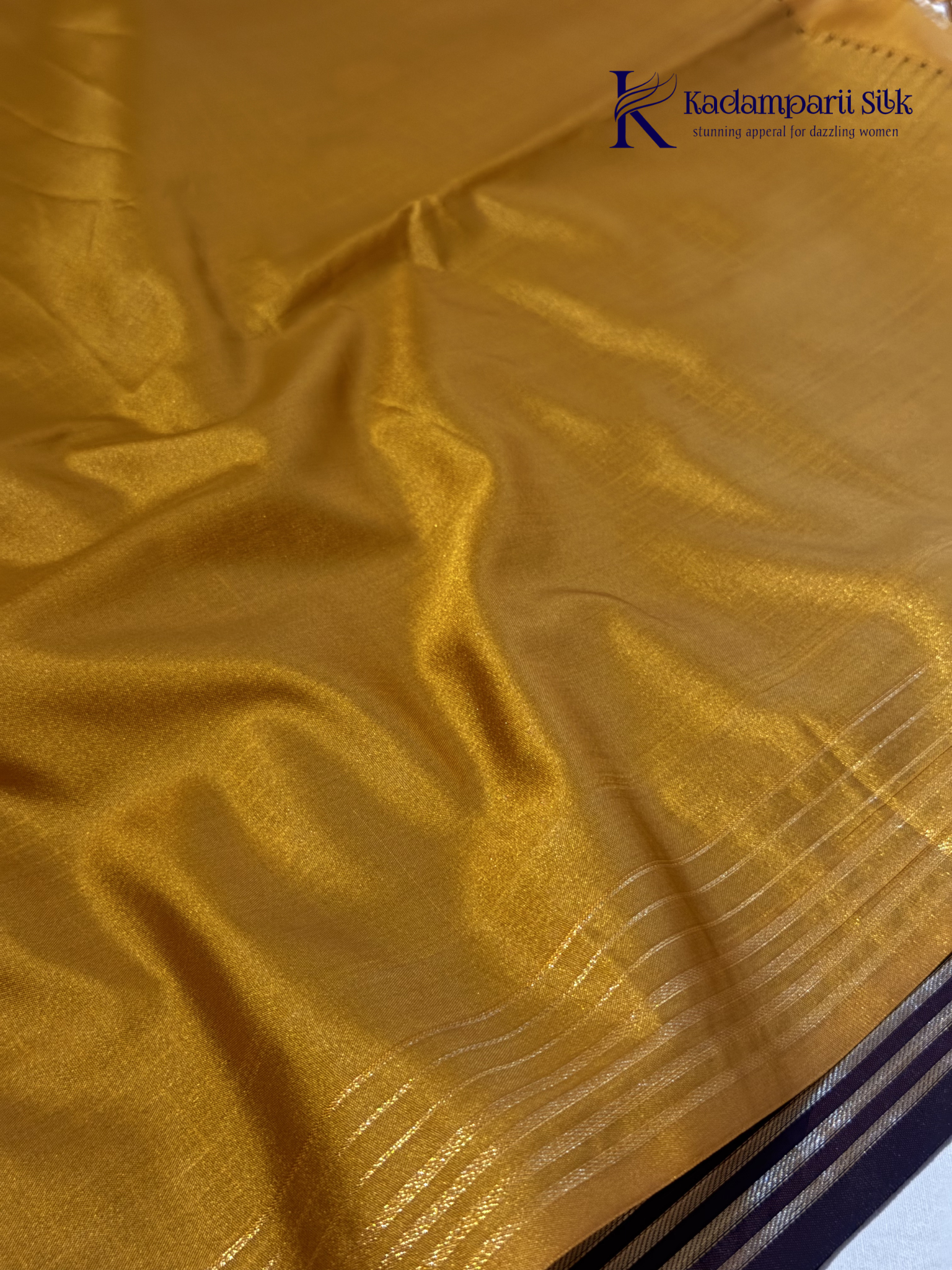 Kadamparii Silk dark chocolate semi soft silk saree with golden checked weaving, zari buttis, rich gold zari pallu, and tassel detailing.
