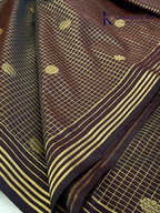 Kadamparii Silk dark chocolate semi soft silk saree with golden checked weaving, zari buttis, rich gold zari pallu, and tassel detailing.