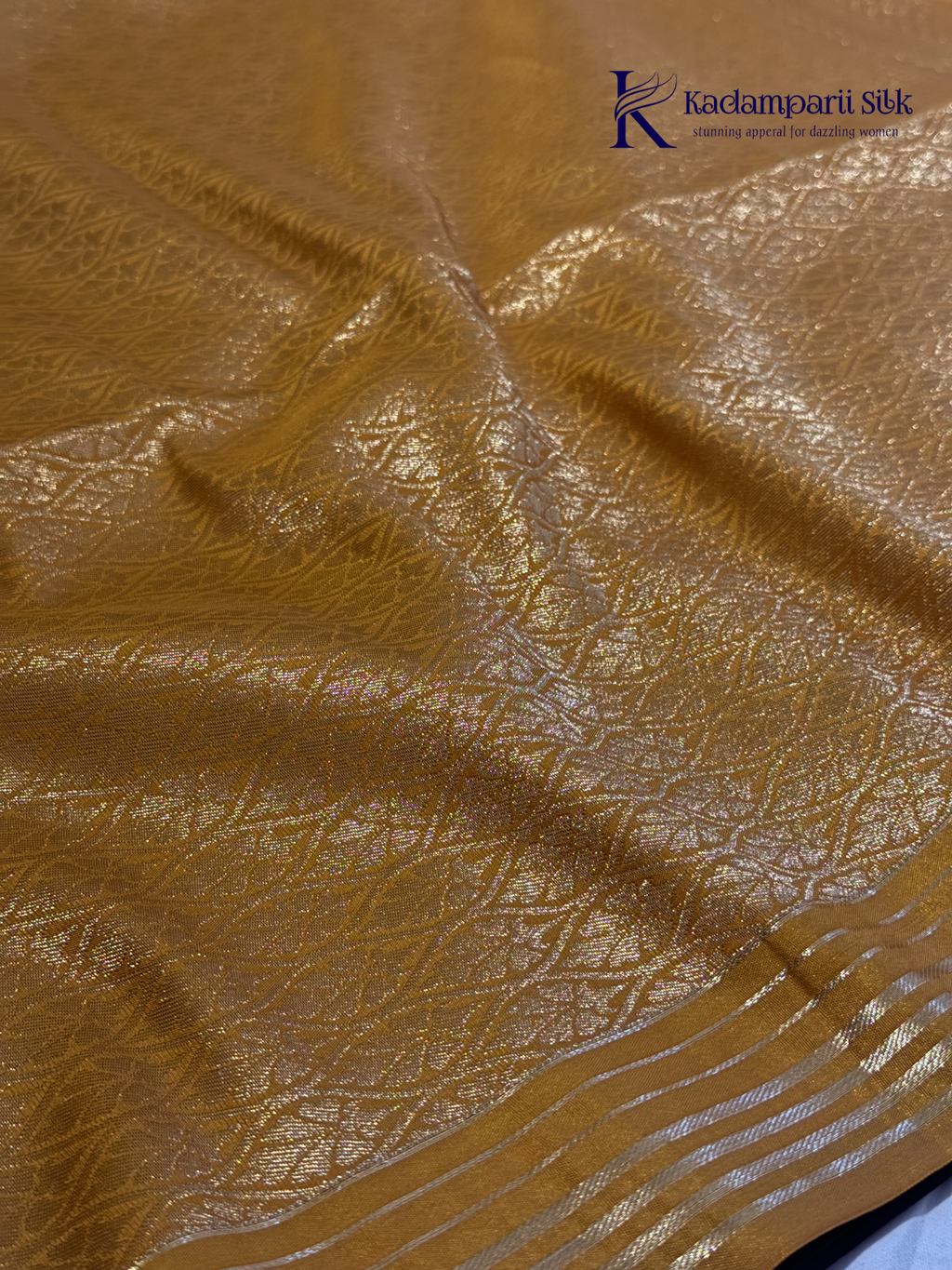 Kadamparii Silk dark chocolate semi soft silk saree with golden checked weaving, zari buttis, rich gold zari pallu, and tassel detailing.