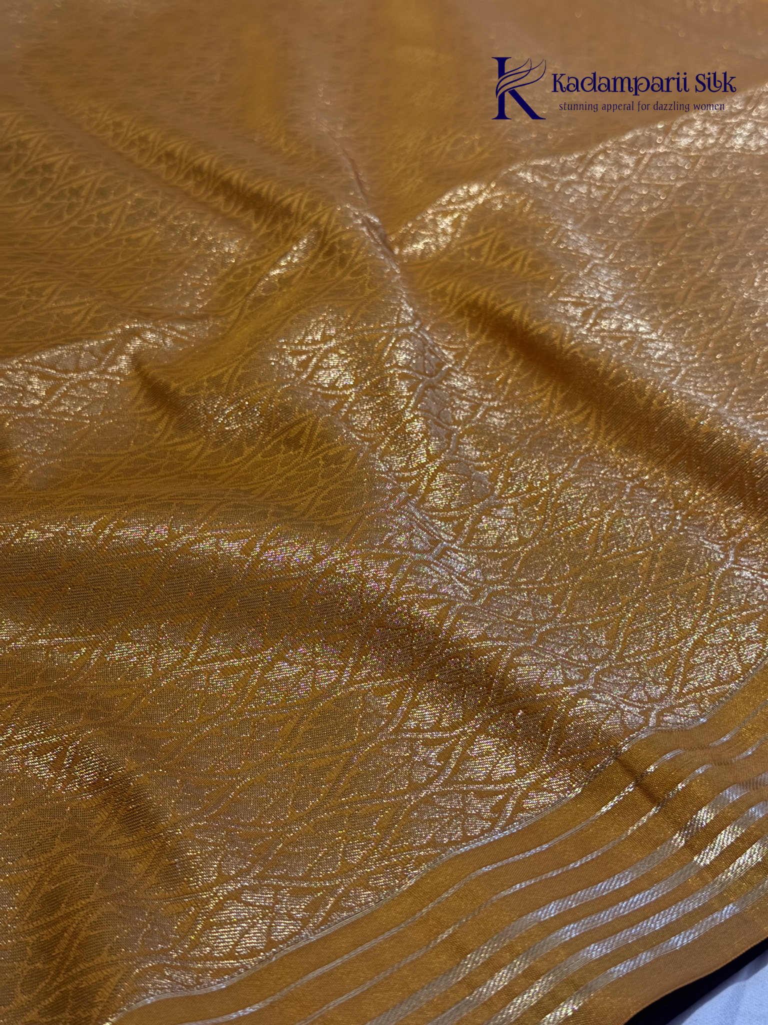 Kadamparii Silk dark chocolate semi soft silk saree with golden checked weaving, zari buttis, rich gold zari pallu, and tassel detailing.