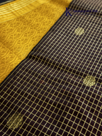 Kadamparii Silk dark chocolate semi soft silk saree with golden checked weaving, zari buttis, rich gold zari pallu, and tassel detailing.
