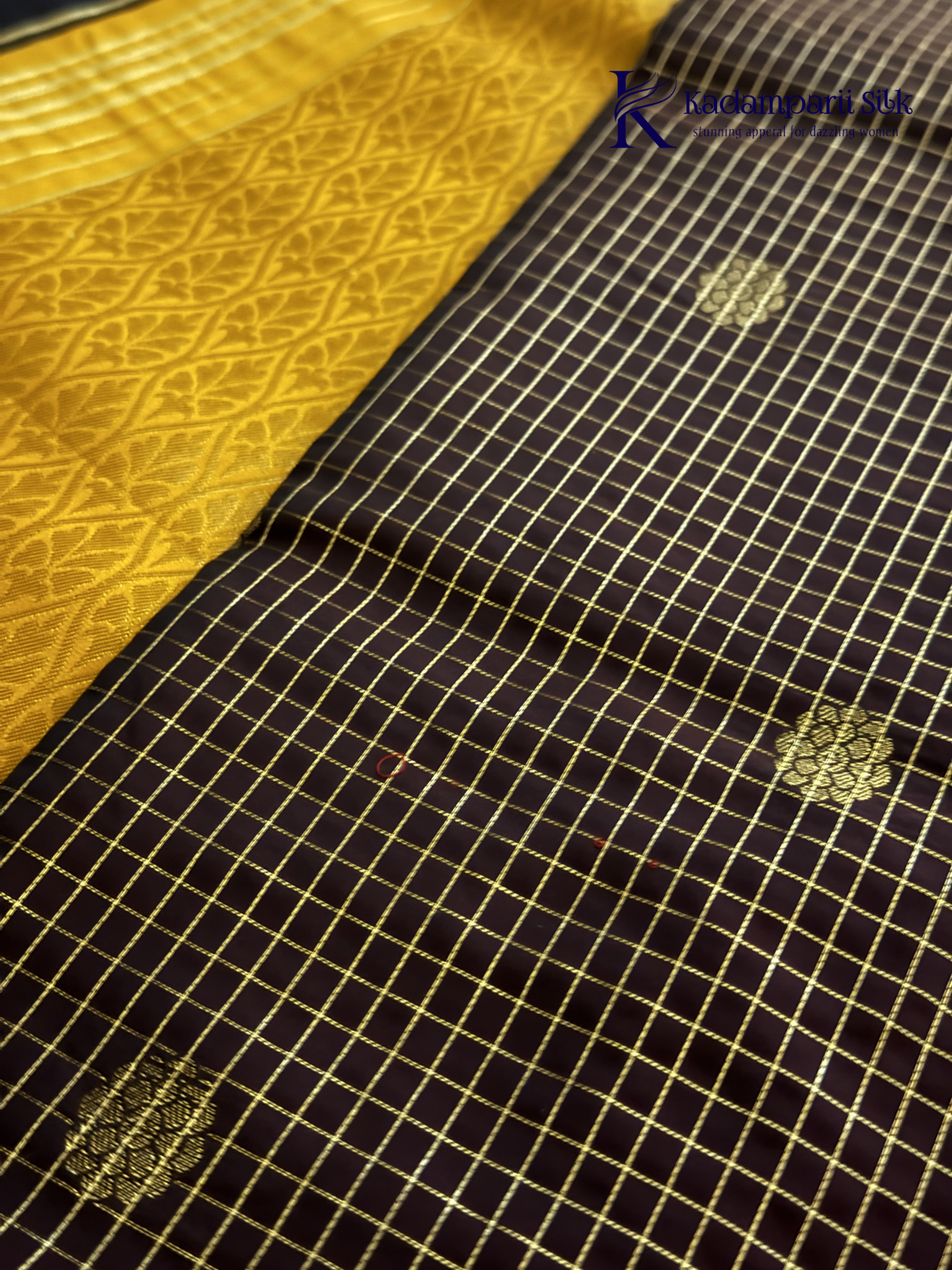 Kadamparii Silk dark chocolate semi soft silk saree with golden checked weaving, zari buttis, rich gold zari pallu, and tassel detailing.